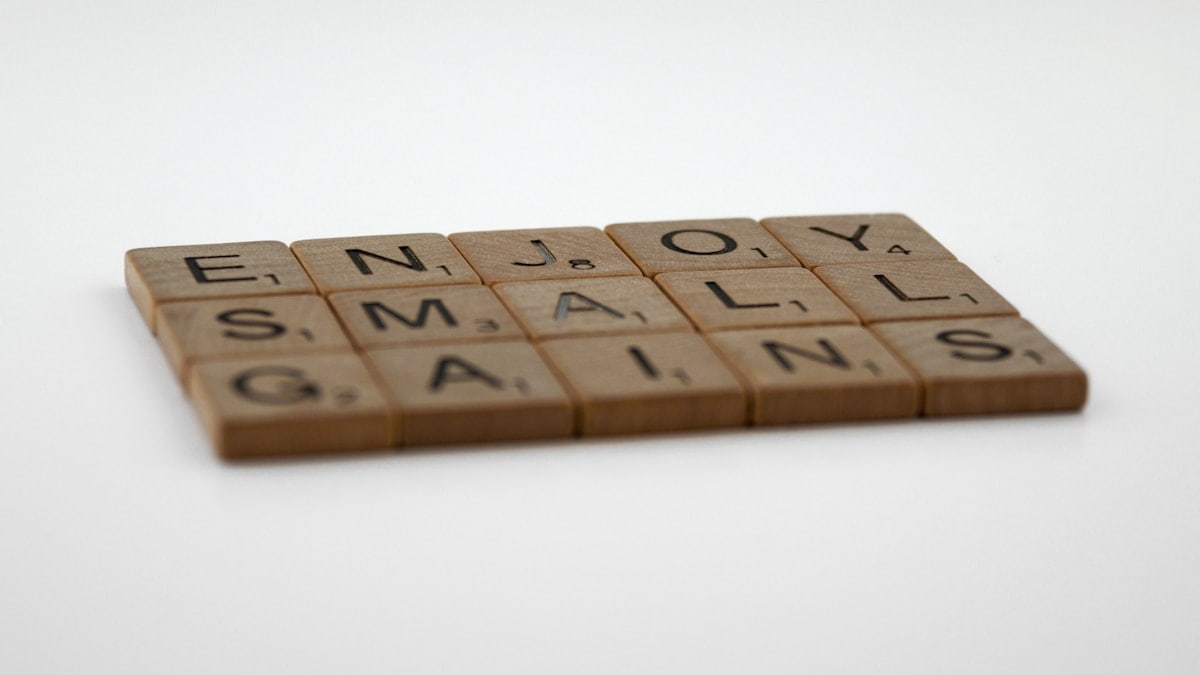 scrabble, scrabble pieces, lettering, letters, wood, scrabble tiles, white background, words, quote, letters, type, typography, design, layout, focus, bokeh, blur, photography, images, image, enjoy small gains, one step at a time, one day a time, incremental gains, measure, progress, steady progress, relentless, training, fitness, weight training, strength training, ageing, never give up, life, love life, optimism, mindfulness, reality, life coach, emotional health,